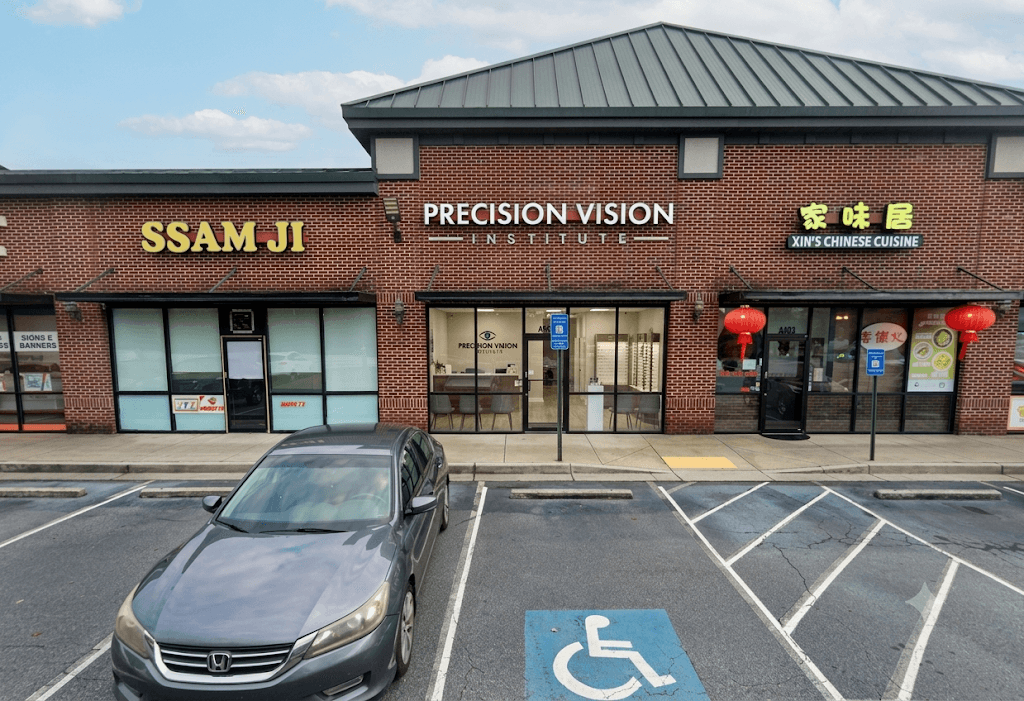 Precision Vision Institute's brick storefront with its white exterior sign at 3940 Buford Highway in Duluth